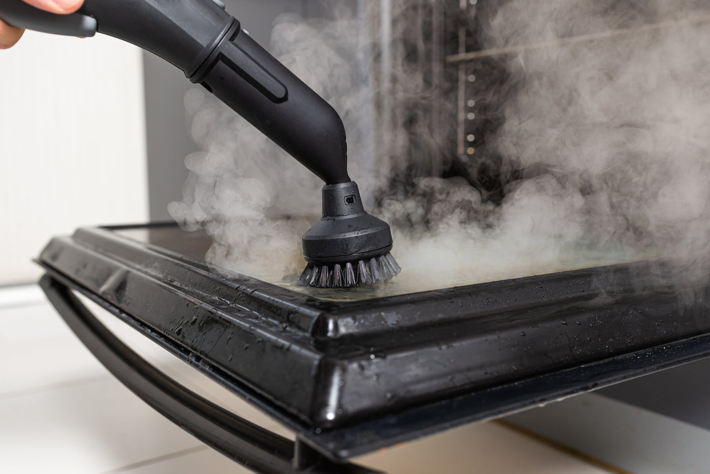 Cleaning the oven with a steam generator