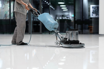 Person using a floor polishing machine on a shiny floor