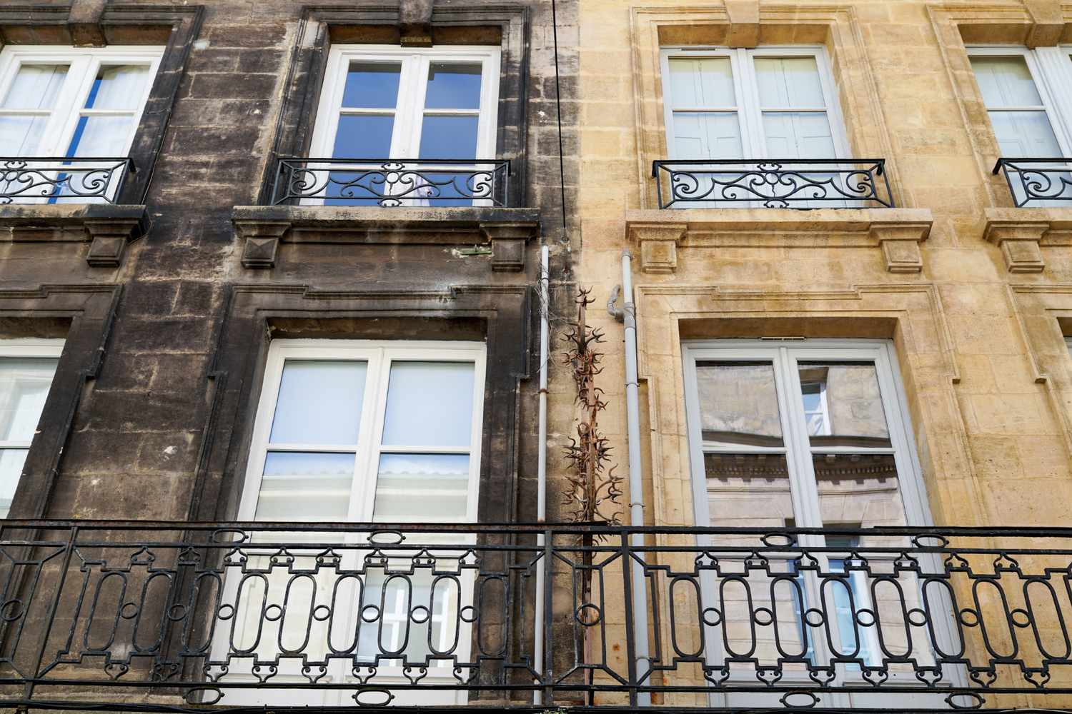 Traditional architectural facade with windows and iron balconies