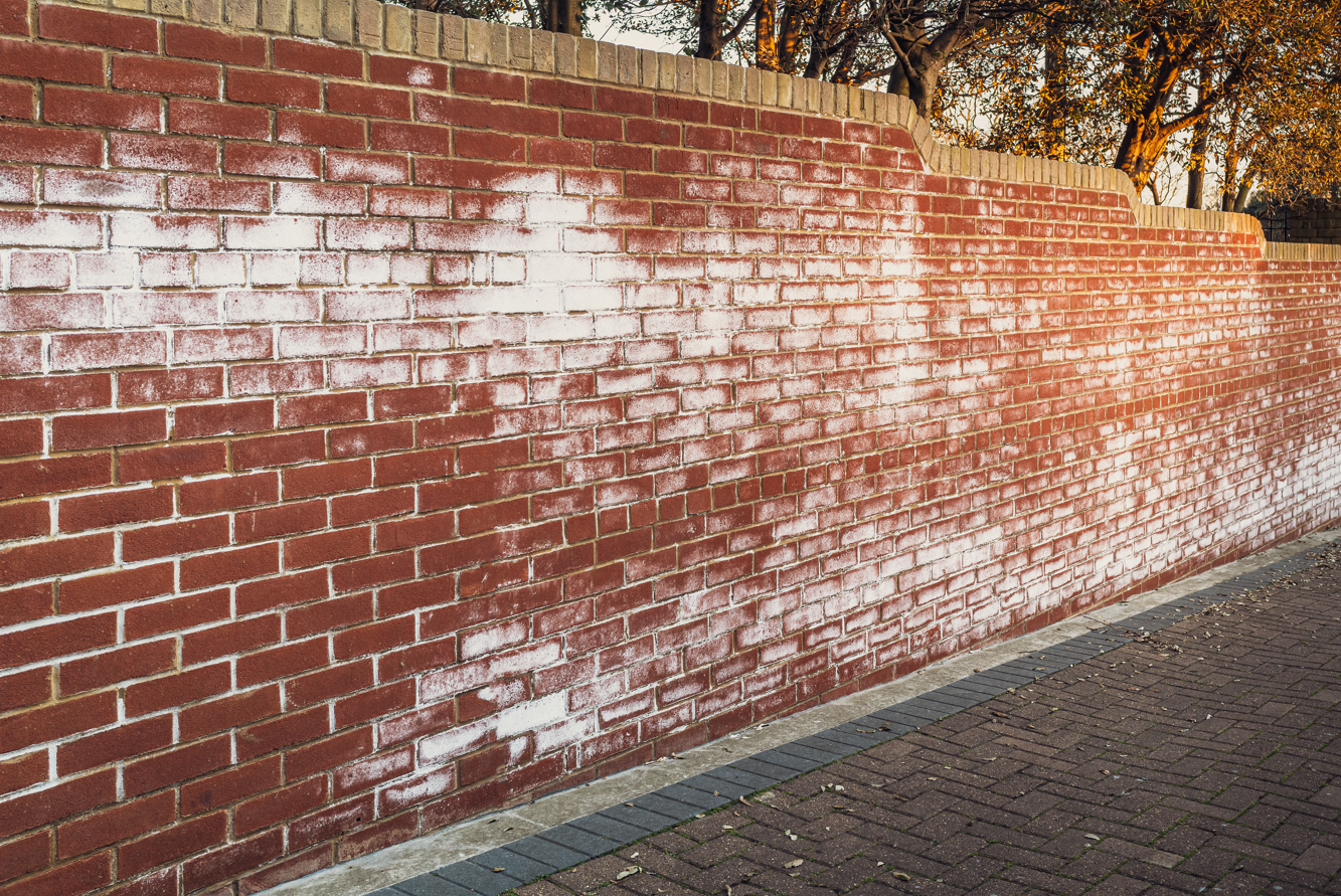 Brick wall with white patches