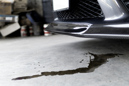 Car with oil spill on a concrete floor in a garage